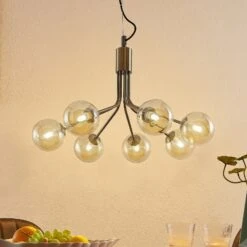 Lucande Wynona Pendelleuchte, 7-fl. Altmessing